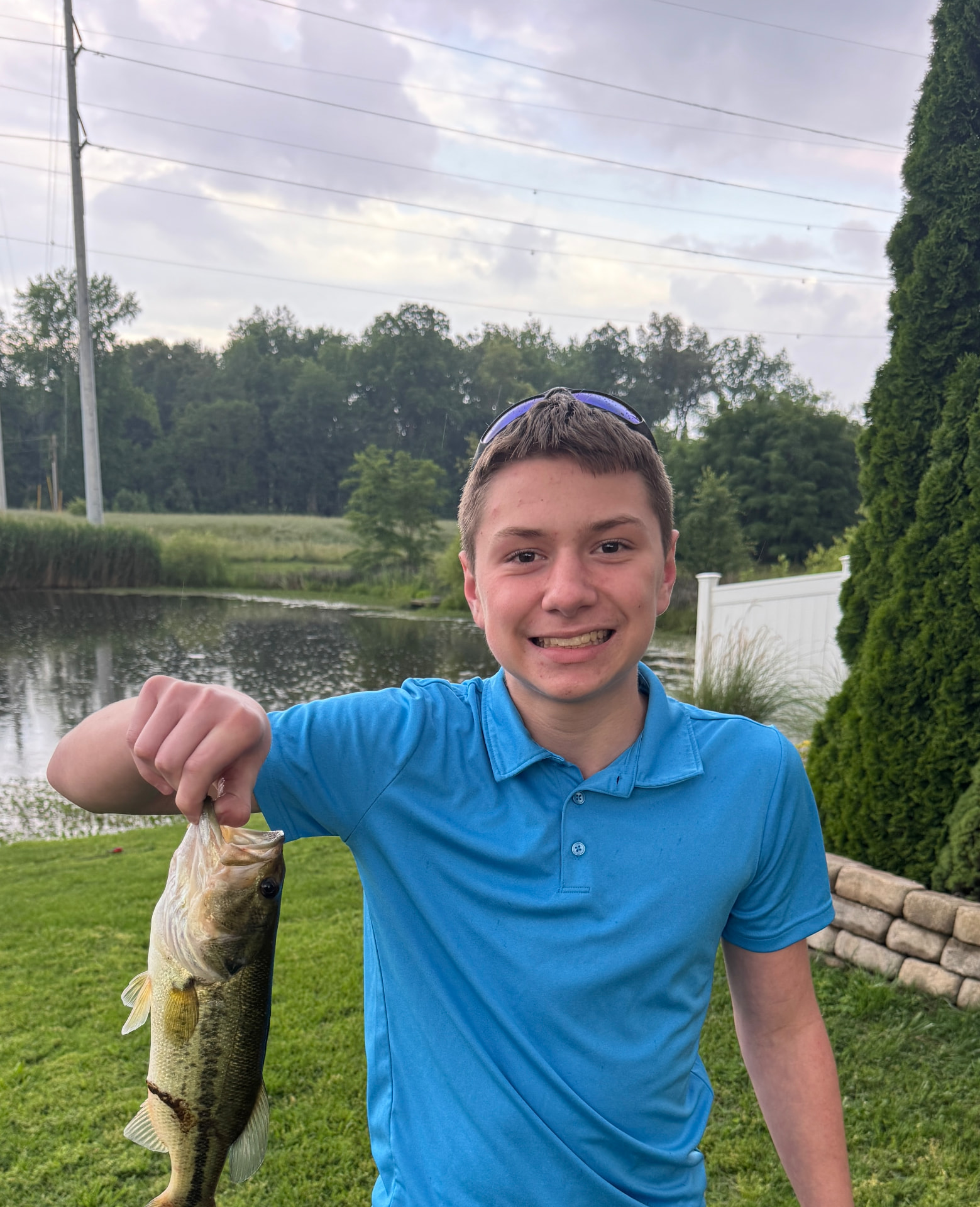 Jase holding a bass he caught